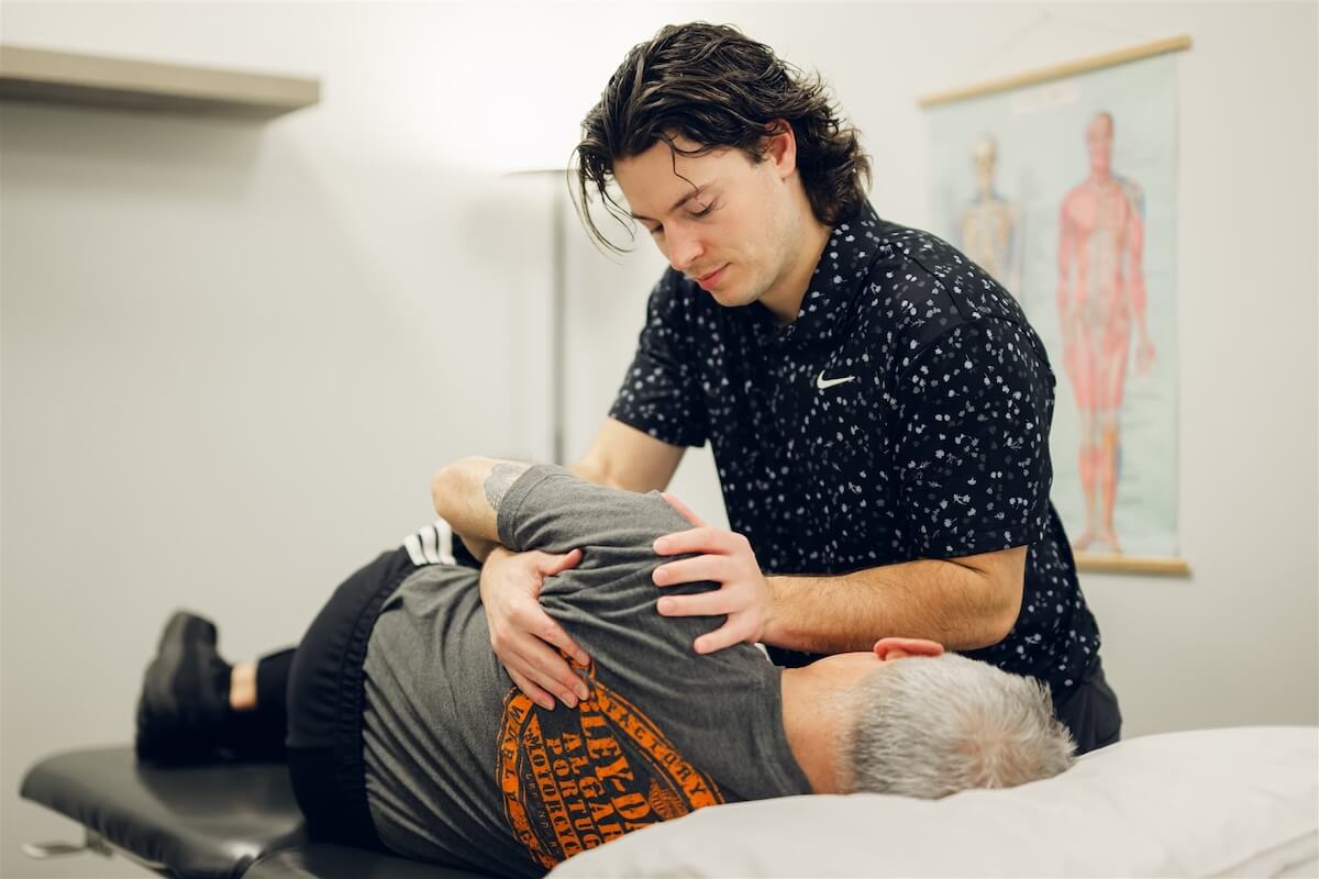 Practitioner treating a client's hip at our Osoyoos clinic